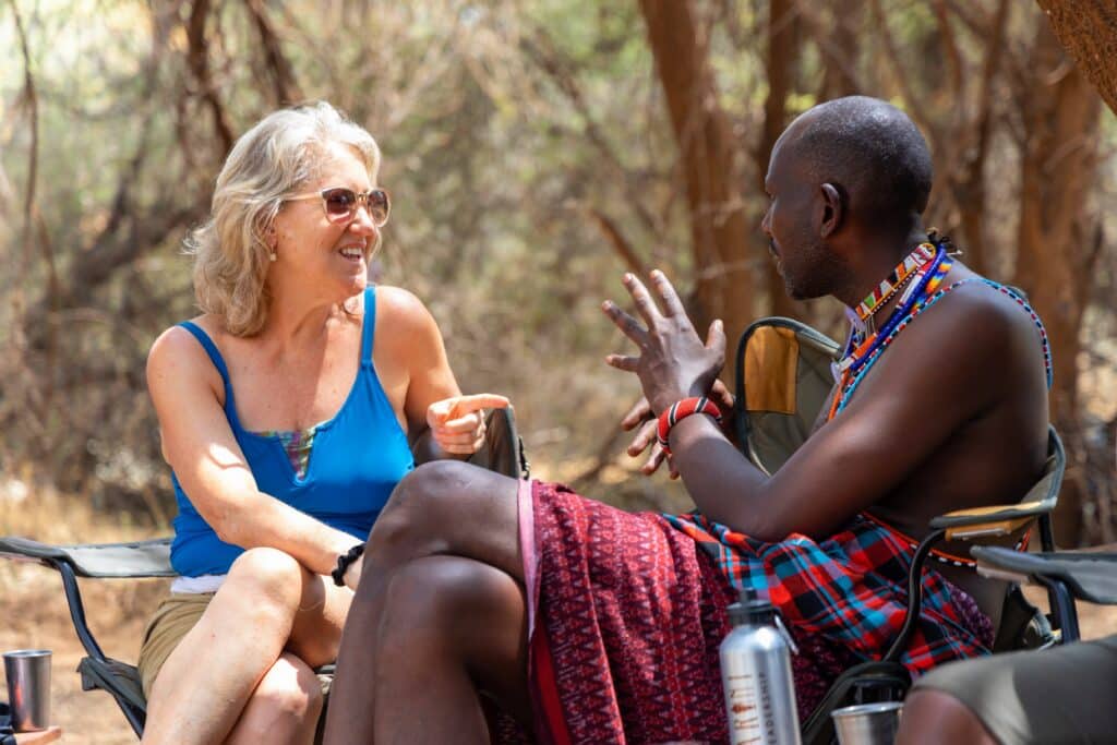 A Samburu facilitator in conversation with a participant at camp